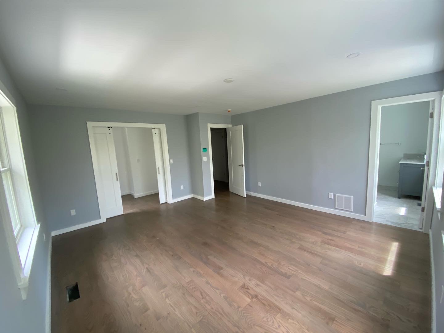Bedroom repainted in soft gray with clean white trim