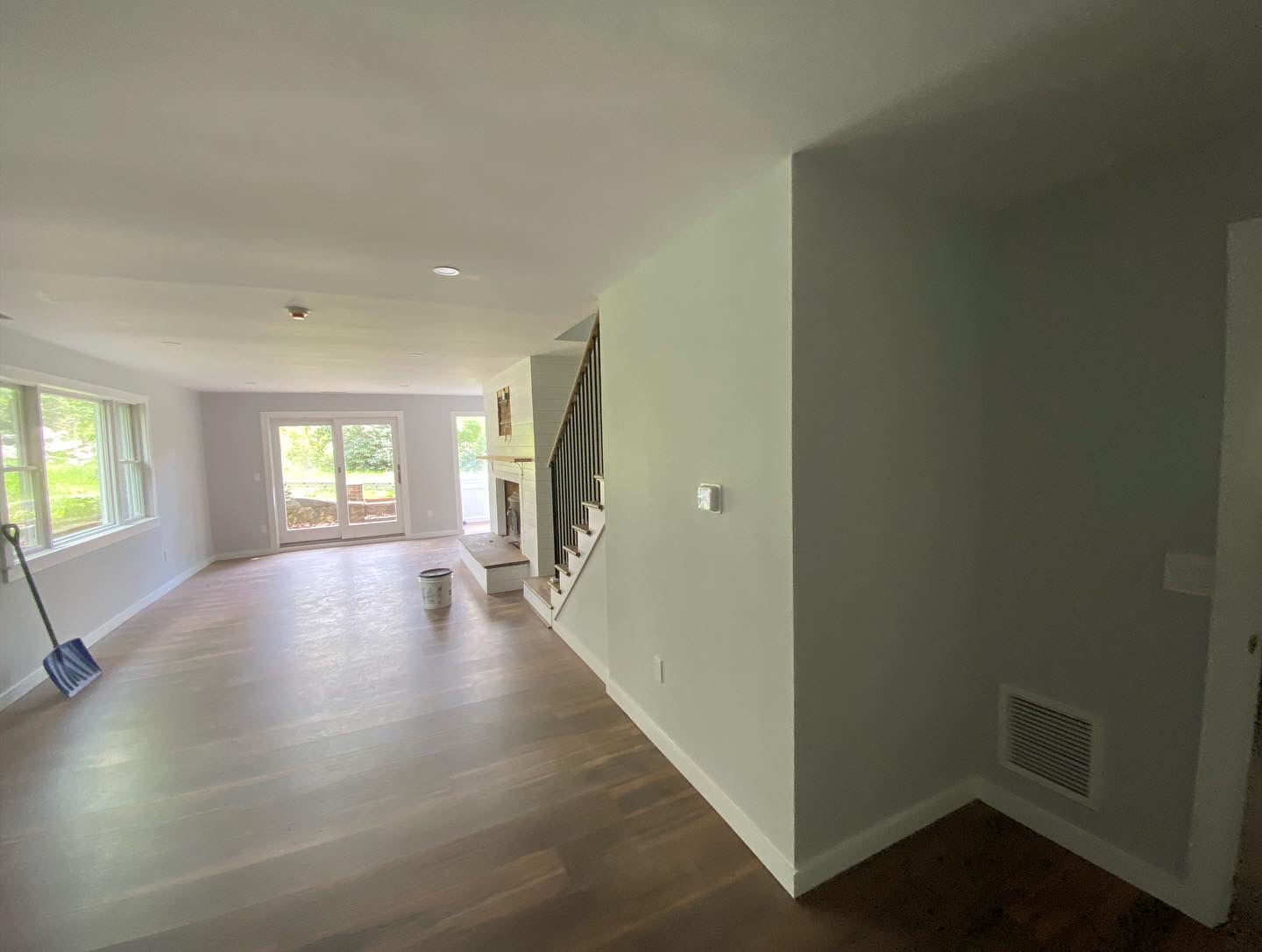 Freshly painted open living area and staircase with clean white trim